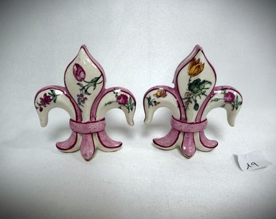 pair of pink and white fleurons with flowers on them