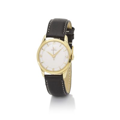 a gold plated wrist watch with a white dial and black leather strap