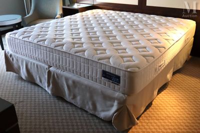 a bed that has a mattress on it in a room