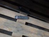a remote control sitting on top of a wooden pallet
