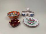 three small bowls and a small bowl on a white table