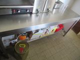 stainless steel counter top with a pot on it in a commercial kitchen
