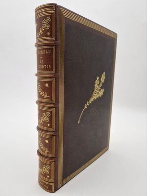 an old book with a gold leaf on top of it