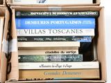 many books in a box that are stacked on top of each other