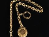 a close up of a gold chain with a locke on it