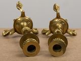 two brass figurines sitting on top of a table