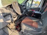 the interior of a van with a car battery in the back seat