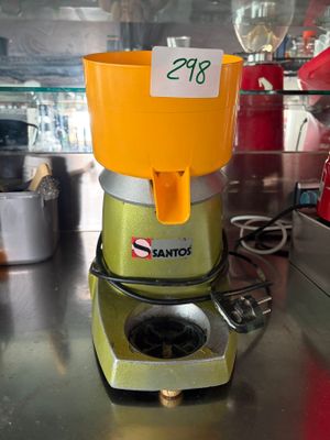 a juicer sitting on a counter with a price tag on it