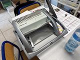 a machine that is sitting on a table next to a bottle of water