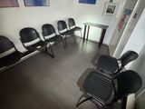 several chairs are lined up in a row in a waiting room