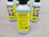 three bottles of cleaning products are sitting on a table
