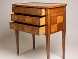 an image of a small wooden table with three drawers