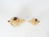 two wooden birds that are sitting next to each other