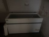a white chest freezer sitting in the corner of a room