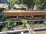 a pile of lumber sitting in the middle of a yard