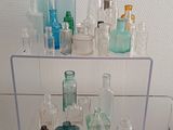 a glass shelf that has various bottles on top of it