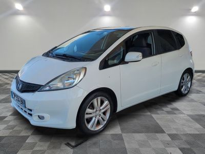 a picture of a white honda fit in a garage