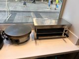 a pan sitting on a counter next to a pan on a stove