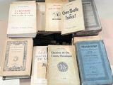 several old books are stacked on top of each other on a table