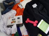 a pile of clothes and other items on a bed