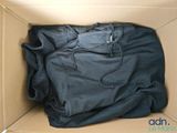 a black shirt in a cardboard box with a black hoodie