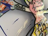 a large piece of graffiti on the wall of a bathroom