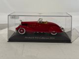 a red model of a car in a clear case
