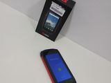 a cell phone sitting next to a box on a table