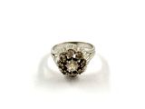 an image of a silver ring with a flower design on it
