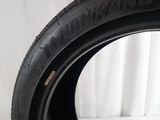 a close up of a tire on a white surface with a white background