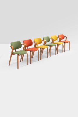 a set of six chairs with colorful upholstered seats