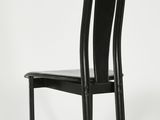 the back of a black chair with a black seat on a white background