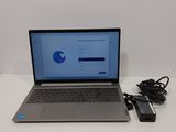 a laptop that is sitting on a table with a charger