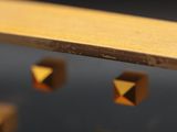 a close up of a wooden shelf with gold studs on it
