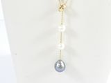 a white mannequin necklace with pearls and a gold chain