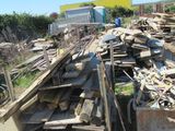a pile of wood sitting on the side of the road
