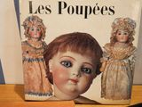 a picture of a book with a picture of a doll on it