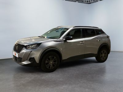 a silver suv is parked in a room with a white wall
