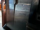 a refrigerator that is in a kitchen with a door open