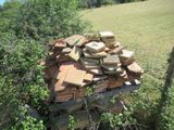 a pile of bricks sitting in the middle of a field