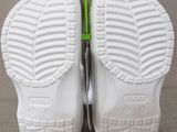 the soles of a pair of white shoes with a green hook