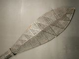 a wooden paddle that has a pattern on it