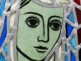 a close up of a stained glass picture of a woman
