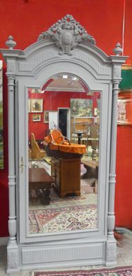 a mirror that is sitting on the floor in front of a red wall