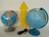 a blue globe and a yellow arrow on a white table