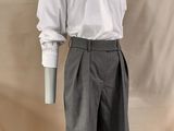 a male mannequin dressed in a white shirt and gray shorts