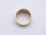 a close up of a gold ring on a white surface