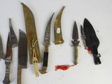a lot of knives that are laying on a table