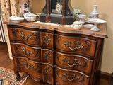 a dresser with a clock on top of it in a room