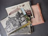 a pile of old postcards sitting on a table